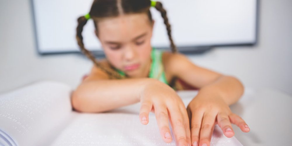 Image of a child using braille